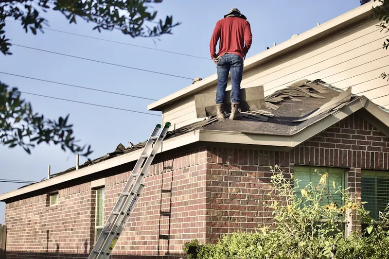 Professional roofer working on a residential roof in Whitemarsh Woods